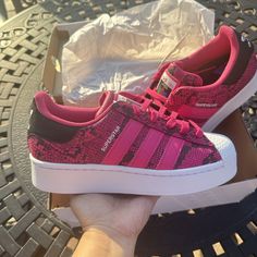 Step Out In Bold Style With These Adidas Superstar Sneakers. The Pink Snakeskin Leather Upper Is Sure To Turn Heads, While The Rubber Outsole Provides Comfort And Durability For Everyday Wear. These Lace-Up Shoes Feature A Standard Shoe Width And Low-Top Shoe Shaft Style, Making Them Perfect For Casual Wear, Workwear, Or Even Activewear. The Adidas Superstar Sneakers Are Part Of The Adidas Superstar Product Line, Known For Their Iconic Three Stripes Design. This Particular Model, With Style Code Pink Adidas Logo Skate Shoes, Adidas Platform Sneakers With Boost Midsole, Adidas Lace-up Platform Sneakers, Branded Heel Counter Low-top Skate Shoes, Adidas Platform Sneakers In Synthetic Material, Adidas Platform Sneakers In Synthetic, Adidas Platform Sneakers With Round Toe, Snake Skin Shoes, Asics Running Shoes