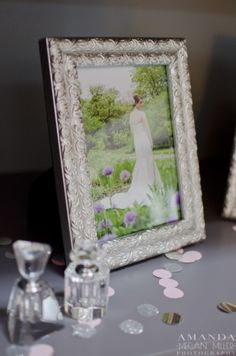 a table topped with pictures and glasses on top of a table covered in confetti