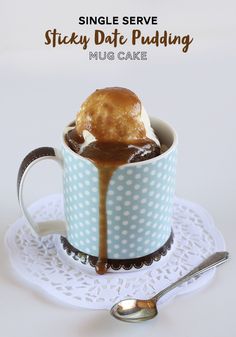 a cup filled with ice cream sitting on top of a doily next to a spoon