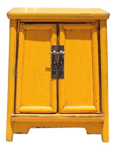 an old yellow wooden cabinet with two doors