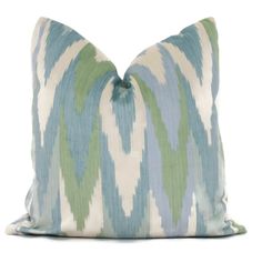 a blue and green pillow on a white background