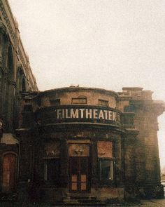 an old building with the word film theater painted on it