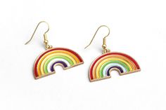 "These sweet rainbow earrings can't wait to spruce up your festival outfit with some serious retro-boho charm! Earring hooks are hypoallergenic. ▲ Rainbow charms measure approx. 1\" x 1 1/8\" ▲ Gold-plated surgical steel earring hooks (hypoallergenic) We try to display product colors as close to life as possible. However, all computer monitors are different and so there might be slight color variations from screen to screen. If you have any questions, feel free to contact us! CARE INSTRUCTIONS J Rainbow Nickel-free Earrings For Gifts, Nickel-free Rainbow Earrings For Gift, Nickel-free Rainbow Earrings Gift, Rainbow Hypoallergenic Earrings As Gift, Colorful Hypoallergenic Dangle Jewelry, Everyday Rainbow Jewelry For Summer, Multicolor Nickel-free Retro Jewelry, Retro Multicolor Nickel-free Jewelry, Everyday Summer Rainbow Jewelry