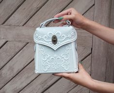 Boho messenger bag, White-Grey crossbody bag, Leather handbag, Shoulder bag, Tooled leather purse, White embossed bag ✔️ Functions: Our handbag offers versatile wearing options to suit your preference and needs. It can be elegantly carried by the handle, slung over the shoulder for convenience, or transformed into a backpack using the additional extension strap.  The compact size of the bag, measuring approximately 17 cm (6.7 in) in width, 19 (7.6 in) cm in height, and 6.5 cm (2.3 in) in depth when closed, ensures it remains lightweight and easy to carry. ✔️ Material: Crafted from strong leather, our handbag is a testament to durability and longevity. The solid construction ensures it can withstand everyday wear and tear, making it an heirloom piece that can be passed down through generati Everyday Embossed Tote Satchel, Embossed Crossbody Satchel For Daily Use, Embossed Crossbody Bag For Everyday Use, Everyday Embossed Crossbody Bag, Embossed Crossbody Shoulder Bag For Daily Use, Embossed Crossbody Shoulder Bag For Everyday Use, Everyday Embossed Crossbody Shoulder Bag, Daily Use Embossed Crossbody Shoulder Bag, Embossed Satchel Shoulder Bag For Everyday Use