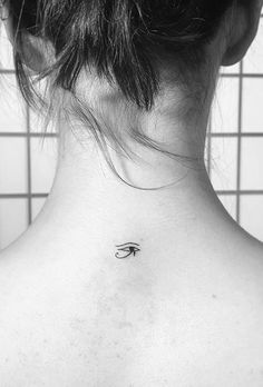 a woman with a small tattoo on her back neck