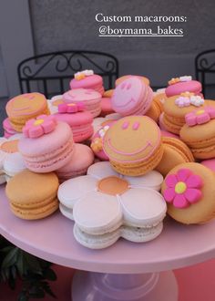 there are many decorated macaroons on the table