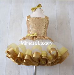 Luxury Gold Outfit Bespoke made to measure dress in gold and Ivory, Perfect for your special occasion! The outfit is made of 3 separate pieces -  including top, skirt and a headpiece Beautiful gold sequin bodice with gold adjustable straps crossed at the back like a corset ensure the perfect fit. The ultra fluffy fully sewn tulle skirt is made of yards and yards soft tulle, edged with yards of beautiful gold ribbons and elasticated on top for maximum comfort. The advantage of having separate pie Elegant Yellow Tutu Dress For Wedding, Elegant Gold Princess Dress With Ruffles, Gold Tulle Dress With Ruffles, Yellow Tutu Dress For Birthday, Gold Ruffled Tutu Dress For Wedding, Gold Princess Dress With Ruffles, Gold Tulle Tutu Dress With Ruffles, Gold Tulle Princess Dress For Wedding, Elegant Gold Princess Dress For Party