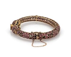 "This is a gorgeous vintage bangle bracelet, it is crafted from 9k rose gold featuring a double snake head joined at the front with a large round ruby mounted in a floral pot above the snakes head. The 9mm wide filigree tube bangle has fany open floral design set with a total of 6 carats rubies! It is hinged and secures with a push in clasp, chain is attached for added security. Material: 9k rose gold Ruby: 6.00 total carat weight Measurements: inner circumference: 6.75\" x 0.36\" wide x 0.32\" Antique Rose Gold Bracelets For Formal Occasions, Traditional Rose Gold Bangle Bracelets, Traditional Rose Gold Bangle Bracelet, Traditional Rose Gold Bracelet Jewelry, Traditional Rose Gold Bracelet, Ruby Bracelets With Intricate Design As Gift, Antique Rose Gold Ruby Jewelry, Ruby Bangle Bracelet With Intricate Design, Snake Bangle