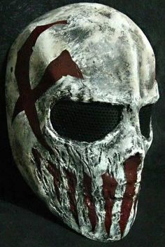 a white mask with red paint on it