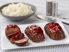 three meatloafs on a plate with mashed potatoes