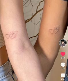 two people with matching tattoos on their arms