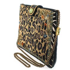 Experience the untamed beauty of this luxurious beaded handbag. This crossbody bag features a beaded animal print pattern enhanced with delicate beaded flowers and intricate jungle-inspired embroidery. The zipper and leather magnet closure with natural Prehnite gemstone will keep all your belongings safe and secure. The chain strap also features Prehnite gemstone accents and can be removed to carry as a clutch. 9.75 x 1 x 7.5" Strap Length End to End: 49" Strap Drop: 23" Removable crossbody chai Luxury Handheld Beaded Shoulder Bag, Luxury Beaded Shoulder Bag For Fashion, Luxury Beaded Bags For Everyday Use, Luxury Beaded Clutch Shoulder Bag, Luxury Beaded Shoulder Bag, Elegant Embellished Travel Bags, Elegant Embellished Shoulder Bag For Travel, Brown Embellished Luxury Bag, Luxury Embellished Brown Bag