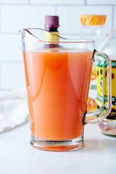 a pitcher filled with liquid sitting on top of a counter