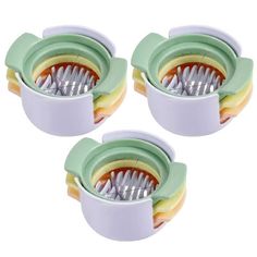 three toothbrush holders sitting next to each other on a white surface with green trim