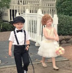 two young children dressed up in formal wear