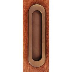 a wooden door handle with an oval design on it