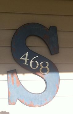 the number six sign is painted blue and has silver numbers on it's sides