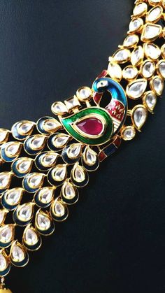 "Look resplendent on your wedding day or any day, wearing this beautiful peacock art deco inspired kundan collar necklace, with glittery kundan stones, meenakari (painted enamel), red crystal stones and large pearls. The peacock's splendid is tail incorporated into the design. You will receive so many compliments wearing this necklace set. Equally fabulous peacock earrings! Excellent quality, this is a a substantial piece, on the heavier side, but it sits flat, comfortably on the collar bone. Co Elegant Multicolor Necklace With Peacock Design, Elegant Multicolor Peacock Design Necklace, Elegant Multicolor Peacock Design Jewelry, Peacock Colored Jewelry For Weddings And Festivals, Kundan Temple Jewelry Sets With Peacock Design, Diwali Kundan Jewelry Set With Peacock Design, Kundan Jewelry Sets With Peacock Design, Elegant Kundan Necklace With Peacock Design For Festive Occasions, Kundan Jewelry Sets With Peacock Design For Diwali