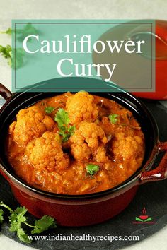 cauliflower curry in a red bowl with cilantro on the side