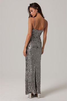 Shine on with our Gunmetal Sequin Maxi Dress! This stunning dress is perfect for any special occasion, with its shimmering silver sequins and flowy maxi length. The ultimate showstopper, this dress will have you feeling confident and glamorous. So go ahead, sparkle and shine with our Gunmetal Sequin Maxi Dress! Gunmetal Sequins Spaghetti straps Open back Maxi dress