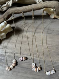 "Beautiful Hawaiian puka shell necklace made with 16k gold filled chain for a minimalist style. All puka shells are handpicked by me from beaches on Oahu's North Shore. I try and pick the best shells with as little flaws as possible! Each shell is medium sized (12-14 mm).  Each necklace is 18\" in length and made with a 16k gold filled chain so it doesn't tarnish. (As always, take care of your jewelry properly to make it last longer). First photos: Hawaiian puka shell bar necklace with gold filled disc. These shells are white and pink colored with a gold filled disc in the center. Second photos: Hawaiian puka shell brown necklace with white bead. I added the bead to separate the pukas and it's not noticeable when wearing since the puka shells are thick.  Fast shipping!  Choose which neckla Puka Shell Earrings, Sea Shell Necklace Puka, Pika Shell Necklace, Niihau Shells Necklaces, Hawaiian Shell Necklaces, Puka Shell Necklace, North Shore Oahu, Puka Shell, Brown Necklace