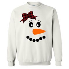 This Snowman With Buffalo Plaid Bow Tee is perfect for this holiday season and beyond. This festive design is a fun way to celebrate the winter season. With both youth and adult shirts available this is a super cute choice to pair with a pair of buffalo paid lounge pants for family Christmas lounge wear sets! This tee also pairs nicely with skinny jeans, vest, and booties for an adorable festive look.  GILDAN Short Sleeve - 6.0 oz. pre-shrunk 100% cotton Long Sleeve - 6.0 oz. pre-shrunk 100% cot Fun Winter T-shirt With Crew Neck, Fun Winter Crew Neck T-shirt, Fun Crew Neck T-shirt For Winter, Fun Crew Neck Winter Tops, Fun Crew Neck Tops For Winter, Cute Cotton Winter T-shirt, Cute Cotton T-shirt For Winter, Funny White Winter T-shirt, Funny White T-shirt For Winter