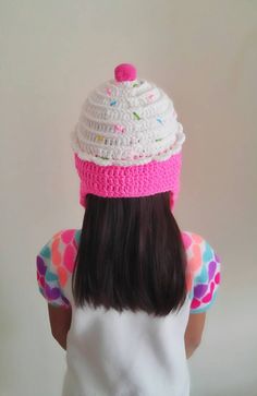 a doll wearing a pink and white knitted hat