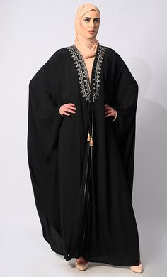 Introducing our exquisite Kaftan inspired shrug a timeless piece of elegance and craftsmanship that embodies the essence of luxury. This shrug features stunning embroidery and hand moti work meticulously arranged on the front panel, adding a touch of opulence to your ensemble. With strings for tying options provided, you can adjust the fit to your preference, ensuring both style and comfort. Crafted with meticulous attention to detail, this kaftan comes with an inner lining, offering a smooth and luxurious feel against your skin. Whether you're lounging by the pool or attending a glamorous event, this kaftan effortlessly combines sophistication with comfort, making it a versatile addition to your wardrobe. Size & FitModel height is 5’9’ and is wearing a Small sizeMaterial & CareMaterial: N Moti Work, Black Kaftan, Black Shrug, Pearl Work, Timeless Pieces, Essence, Pool, Wardrobe, Skin