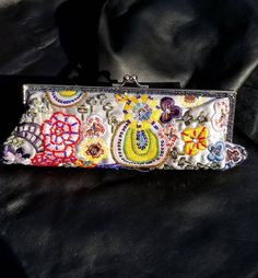 Fabulous embroidered purse! This bag was bought on one of my trips to Amsterdam. This clutch also has a silver 14" inch  chain that is detachable.  Inside little pocket. Bag measures 10" inches across, and 4" inches tall. Alot of handiwork on this bag, embroidery, sequins, rhinestones, metallic stitching, glass beads. Near the top of bag there is also 2 rows of little black iridescent seed beads.  This bag has Never been worn.  Thanks, Enjoy! #fashion #style #bohostyle #festival #dope #folk #tribe #gift #hippie #amazing #gorgeous #ethnic #tribal #fabulous #awesome #wedding #bride #bridal Handmade Bohemian Clutch For Spring, Handmade Bohemian Spring Clutch, Bohemian Evening Rectangular Clutch, Bohemian Rectangular Clutch For Spring, Bohemian Embellished Rectangular Evening Bag, Handmade Clutch For Evening In Spring, Bohemian Handmade Silver Bag, Spring Bohemian Rectangular Clutch, Handmade Bohemian Silver Bag