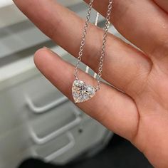 A heart-shaped diamond necklace, featuring a minimalist design, epitomizes elegance through its simplicity. The diamond delicately set without bezel takes center stage without distraction. The chains are available in different length ranging from 14 inches to 18 inches, available in 14K and 18K gold karats, and white, yellow, or rose color. You may also choose  your diamond size starting from 0.5 to 3 carats. Customize your necklace using the drop-down menus. This listing features a lab grown diamond. Lab grown diamonds have identical physical, chemical, and optical properties to mined diamonds, including hardness, brilliance, and fire, at a more affordable price point. Lab diamonds are also more environmental friendly and conflict-free. They are graded using the same 4C standards as mined Minimalist Heart Shaped Diamond Necklace, Minimalist Heart-shaped Diamond Necklace, Heart Cut Moissanite Necklaces For Anniversary, Heart Cut Moissanite Necklace For Anniversary, White Heart-shaped Moissanite Jewelry, Diamond White Heart Solitaire Necklace, Heart Shaped Solitaire Necklace Vvs Clarity, Minimalist Diamond Necklace With Heart Charm, Minimalist Diamond Heart Necklace For Anniversary