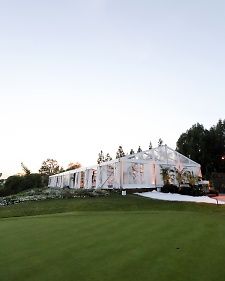 a large white house sitting on top of a lush green field