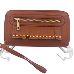 Brand: Unbranded Style: Zip Flap Wallet Wristlet Color: Tan Size: Os Hardware: Gold Tone Metal Material: Non Leather Measurements: 7.5” W X 4.5” H X 1” D Weight: 9.6 Oz Features: Front Fringe Stud Decor W/ Front Zippered Pocket. Front Top Zippered Pocket W/ Four Card Slip Pockets, Two Slip Pockets, & Middle Zippered Pocket. Back Top Zippered Pocket W/Two Compartments. Attachment Wristlet Strap Made In Unknown Condition: Nwot Note: Please View All Pictures For Details & Condition. Trendy Brown Rectangular Wristlet, Trendy Brown Wristlet For Travel, Brown Wristlet With Card Slots For Daily Use, Brown Wristlet Clutch With Card Slots, Trendy Brown Wristlet With Zipper Closure, Trendy Brown Wristlet For Everyday, Lv Waist Bag, Louis Vuitton Bumbag, Louis Vuitton Felicie Pochette