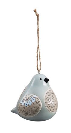 a ceramic bird ornament hanging from a rope