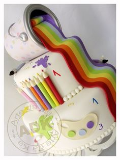 there is a cake made to look like a unicorn with lots of paintbrushes