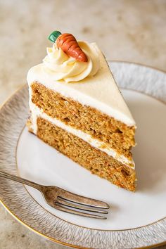 a slice of carrot cake on a plate with a fork