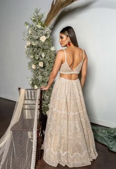 This net lehenga set features all over pearl embroidery and is paired with a tulle dupatta and an embroidered belt.﻿From Seema Gujral's Reverie collection. DELIVERY TIMEPlease allow 4-6 months for your outfit to arrive. FABRIC DETAILSNet. Professional cleaning only. Blue Sequin Lehenga, American Indian Dress, Beige Lehenga, Sequin Lehenga, Peach Lehenga, Golden Feather, Seema Gujral, Gold Lehenga, Mirror Work Lehenga