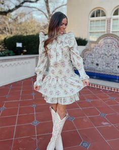 Saddle up in style with the Quinlynn Taupe Floral Ruffle Bow Dress. This versatile dress is perfect for any occasion, whether you're hitting the rodeo in your cowgirl boots or stepping out in the spring sun with wedges. With its playful ruffle and bow details, you'll be the talk of the town. Giddy up and grab yours today! Product Details: Features: Adjustable bow tie. Ruffle details. Side zipper closure. Fit: True to size. Model is 5'3 and wearing a size small. Fabric: 100% cotton; Lining- 100% Fall Ruffled Mini Dress For Garden Party, Spring Mini Dress With Ruffle Hem For Day Out, Talk Of The Town, Bow Dress, Versatile Dress, The Talk, Versatile Dresses, Floral Ruffle, Stepping Out