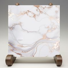 a white and gold marble block with wooden wheels on an isolated grey background, showing the top part of it's design