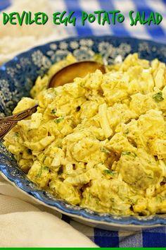 an egg salad in a blue bowl with a wooden spoon on the side and text overlay that reads, deviled egg potato salad