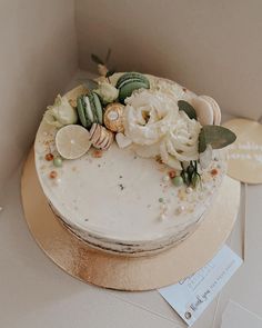 there is a cake with flowers on the top and shells on the bottom, along with other decorations