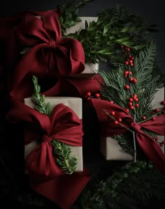 presents wrapped in red ribbon with holly and berries on them, sitting next to each other