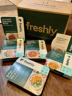 four boxes of freshy are sitting on a table next to a box of cereal