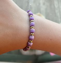 Clay bead bracelet with 2 shades of purple and gold beads in a repeating pattern. This bracelet is 2 inches in diameter and would be suitable for a child or young adult/adult with a smaller wrist. There is a little stretch, but not much. Adjustable Purple Bracelets With Tiny Beads, Adjustable Purple Bracelet With Tiny Beads, Purple Tiny Beads Beaded Bracelets As Gift, Adjustable Lavender Bracelet With Tiny Beads, Adjustable Purple Stretch Bracelet For Friendship, Casual Purple Hypoallergenic Bracelets, Purple Stretch Bracelet With Letter Beads, Purple Stretch Bracelet With Tiny Beads As Gift, Adjustable Lavender Stretch Bracelet