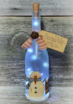 a glass bottle with a snowman on it