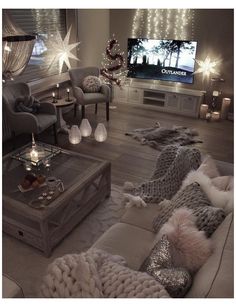 a living room filled with furniture and christmas lights