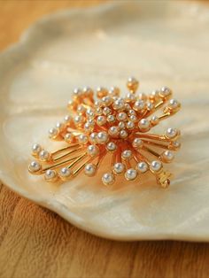 Introducing our Vintage Fashion Pearl Firework Brooches - a charming and stylish accessory, they offer a gorgeous and luxurious look thanks to their unique vintage inspired design. Perfect for both casual and formal attire, these brooches display vintage-inspired fashion and timeless elegance. Metal: 18K Recycled Gold Plated On Brass Gemstone:Imported artificial pearls Dimensions:45*50mm Weight: 26.5g Elegant Brooches For Vintage Events, Elegant Brooch Pins For Vintage Events, Elegant Vintage Brooch Pins, Elegant Gold Brooches For Party, Luxury Brooch Pins For Wedding, Elegant Gold Pins, Luxury Wedding Brooch Pins, Luxury Wedding Brooch, Elegant Gold Brooch Pins