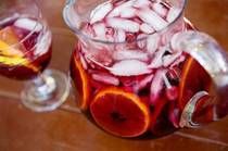 two glasses filled with liquid sitting on top of a wooden table