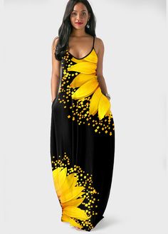 a woman wearing a black and yellow dress with sunflowers on the side, standing in front of a white background