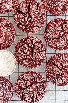 red velvet cookies with white sprinkles on a cooling rack