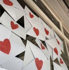 some paper hearts are hanging on the wall